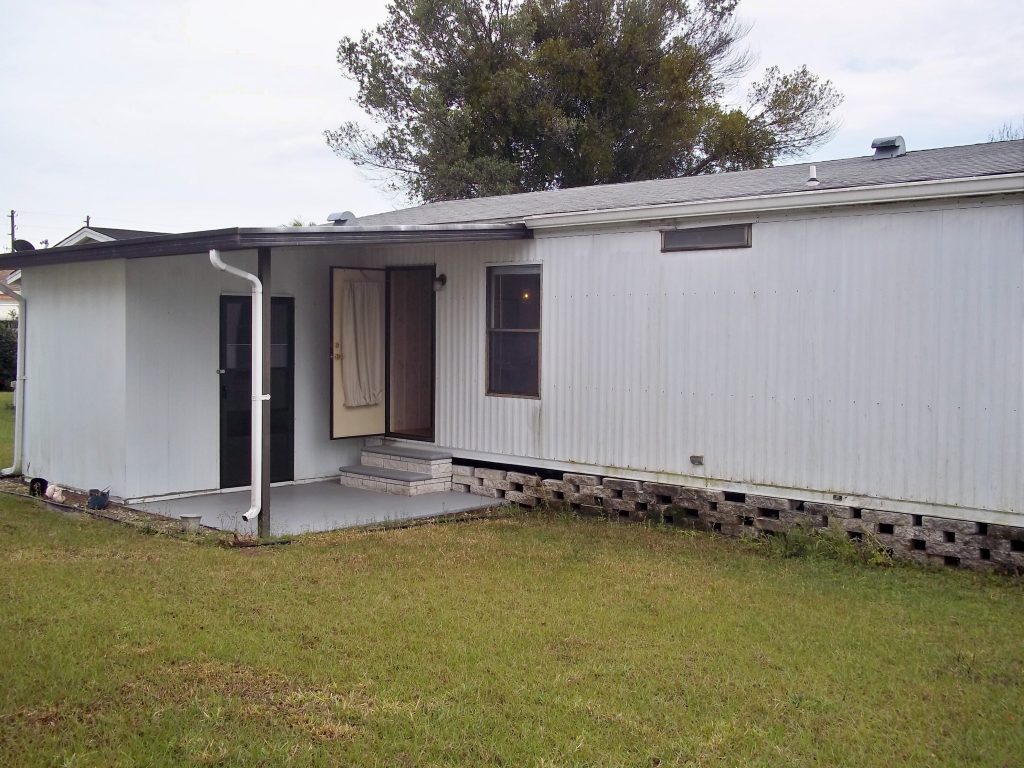 Backside view. Shed. Lush green lawn